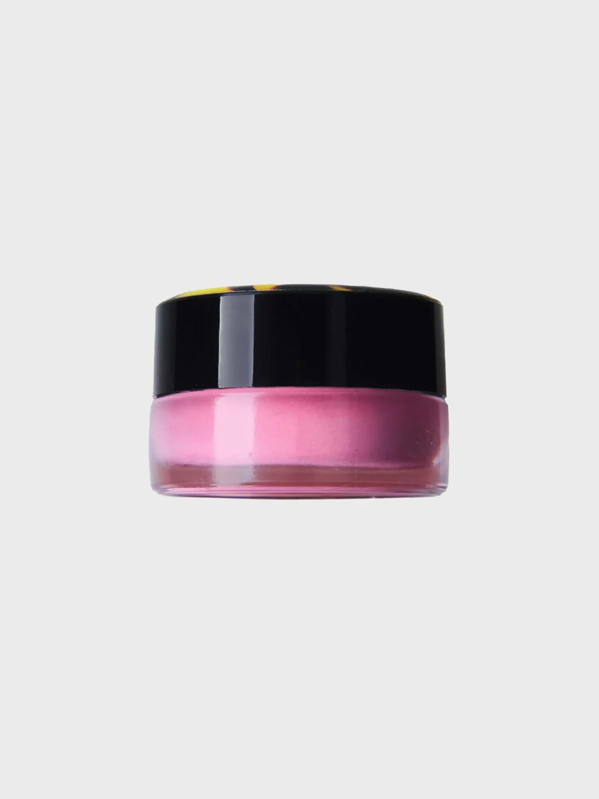 Mousse blush in a clear glass jar of soft pink with a glossy black lid, shown from the side