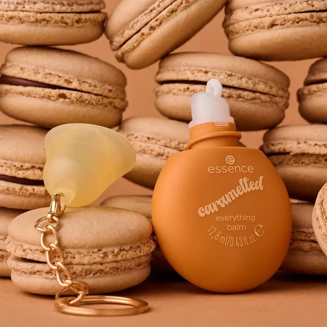 essence caramelted Everything Balm and a pear-shaped keychain balm among macarons