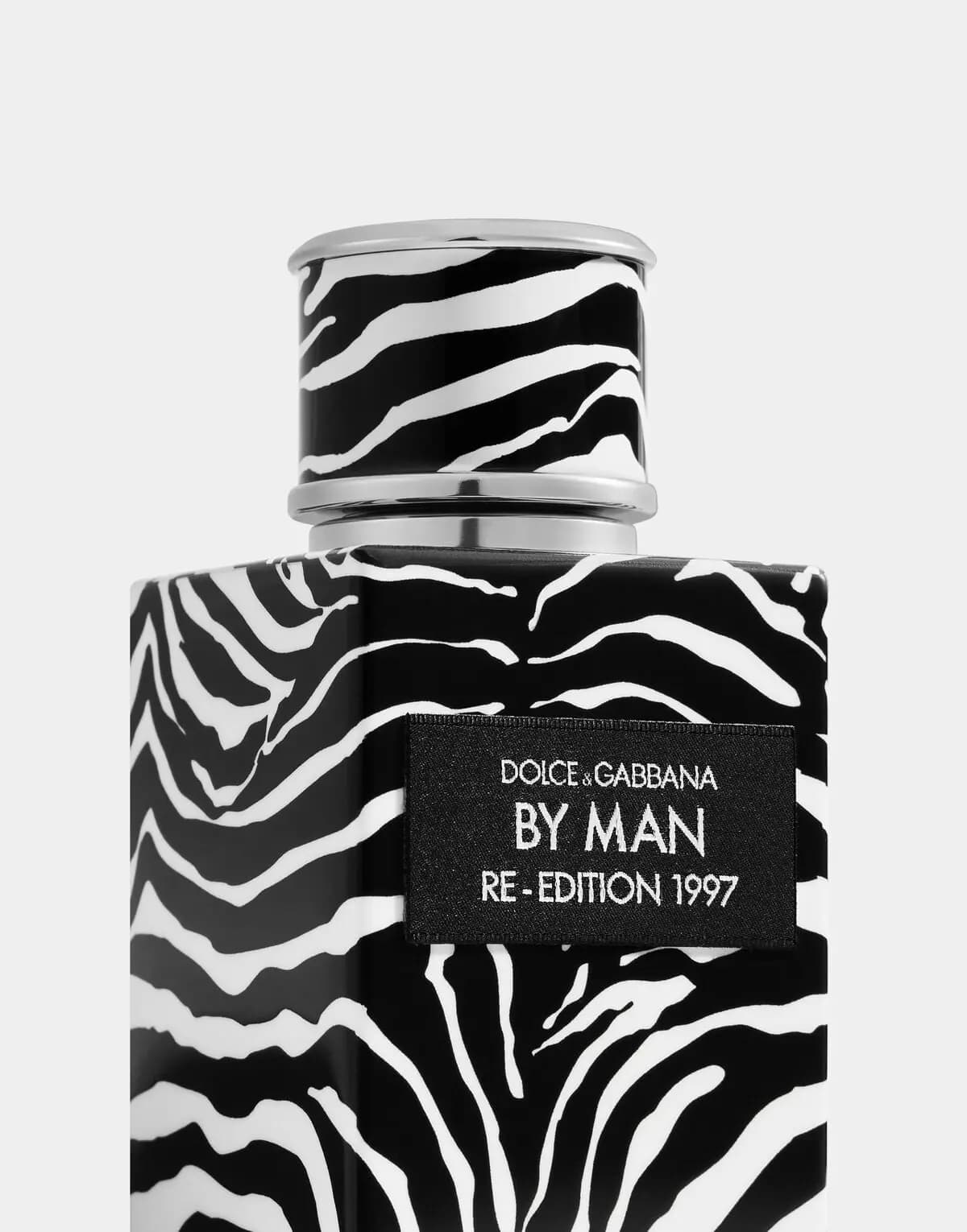 Close-up of the zebra-print cap and black textile label embroidered in silver