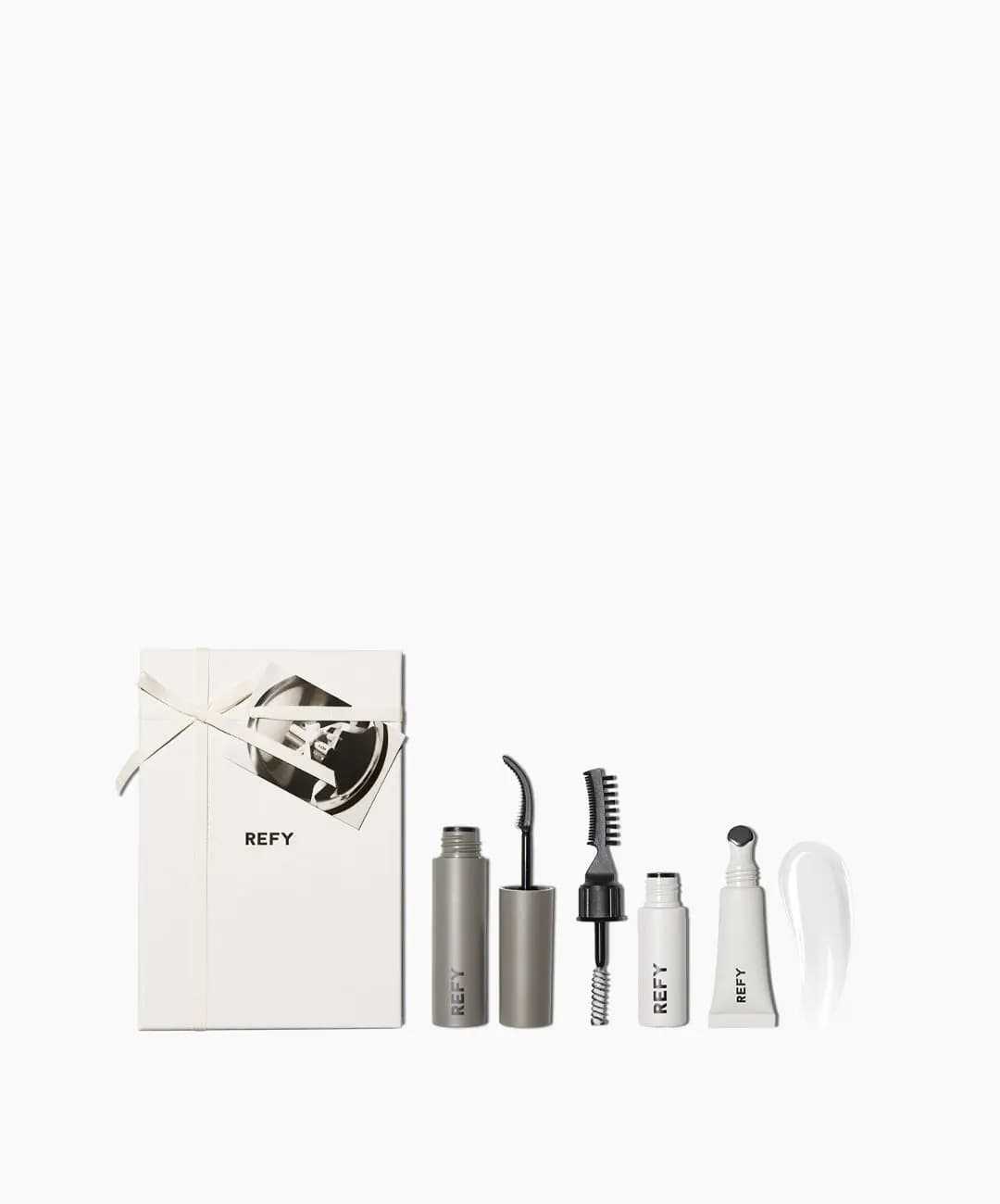 Small ribboned REFY box with mini mascara, brow gel and lip gloss beside a clear gloss swatch