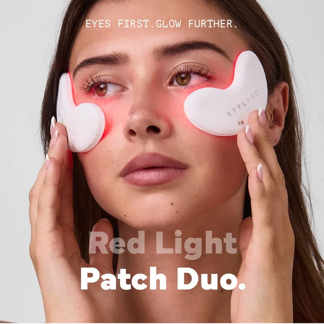 Model holding glowing white STYLPRO LED patches under her eyes beneath the headline Red Light Patch Duo