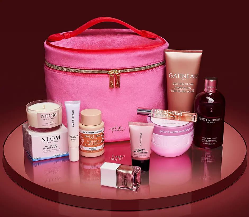 Pink velvet vanity case surrounded by NEOM candle, Laura Mercier primer, Nails Inc, Gatineau, Molton Brown and more products.