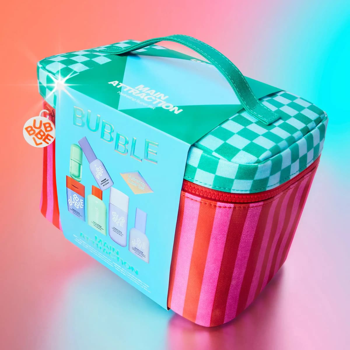 Main Attraction Hydrating Super Set travel case with teal sleeve, angled on a glowing pink and aqua backdrop