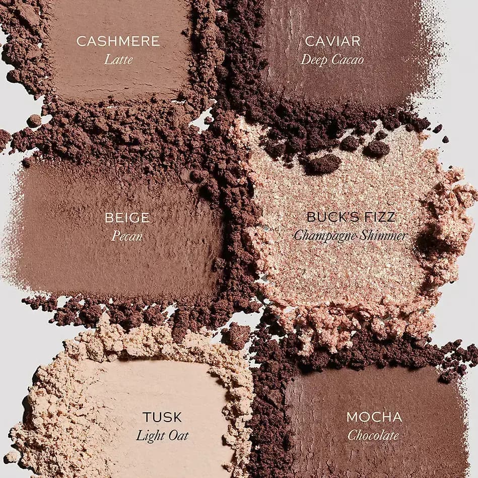 Crushed powder swatches labelled Cashmere, Caviar, Beige, Buck's Fizz, Tusk and Mocha, with one champagne shimmer