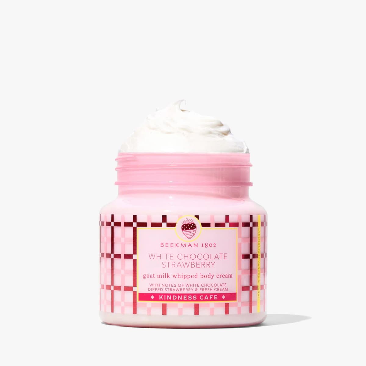 Open pink jar of Beekman 1802 White Chocolate Strawberry goat milk whipped body cream with fluffy swirl on top
