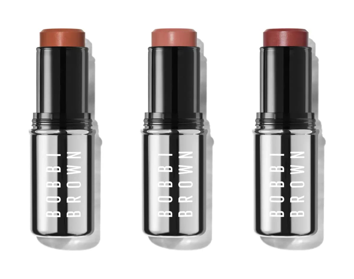 Three Bobbi Brown Skin Enhancer Multi-Sticks in terracotta, peachy pink and berry shades with mirrored black cases.