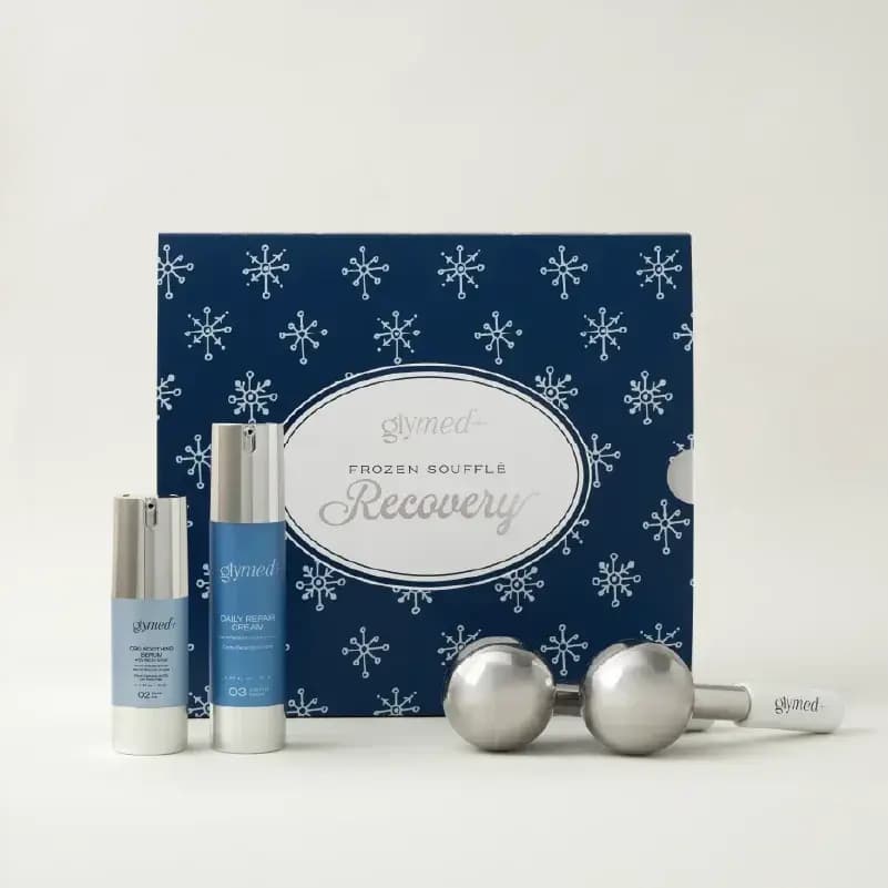 GlyMed+ Frozen Soufflé Recovery set: serum, Daily Repair Cream and steel ice globes before a navy snowflake box