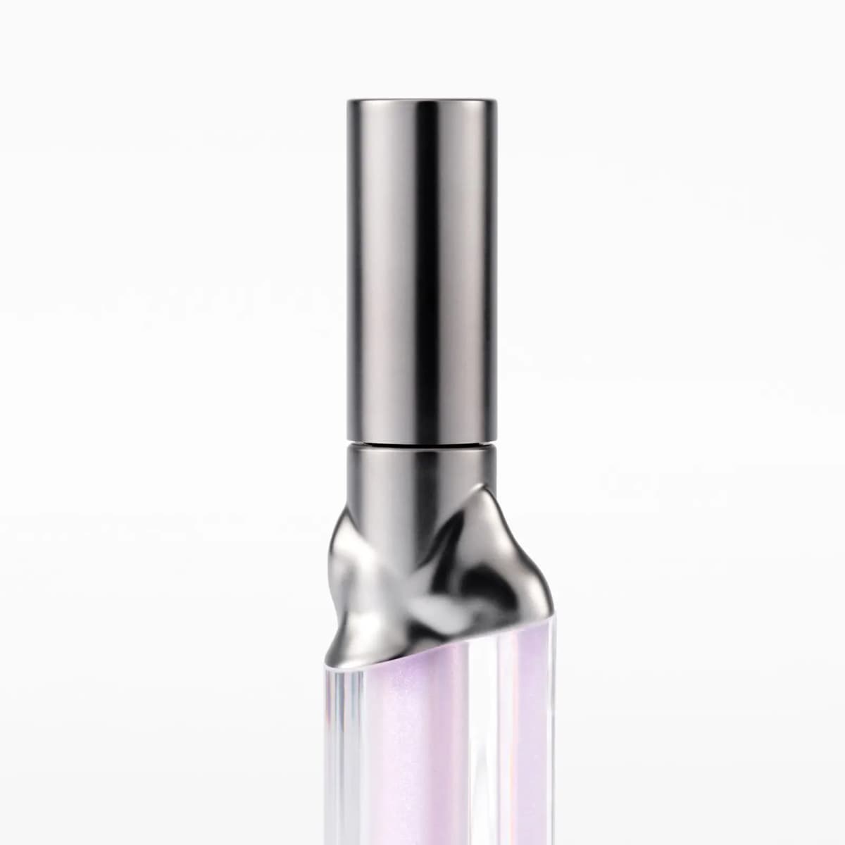 Close-up of the lip tube's gunmetal cap and molten-look sculpted metal collar over lilac shimmer