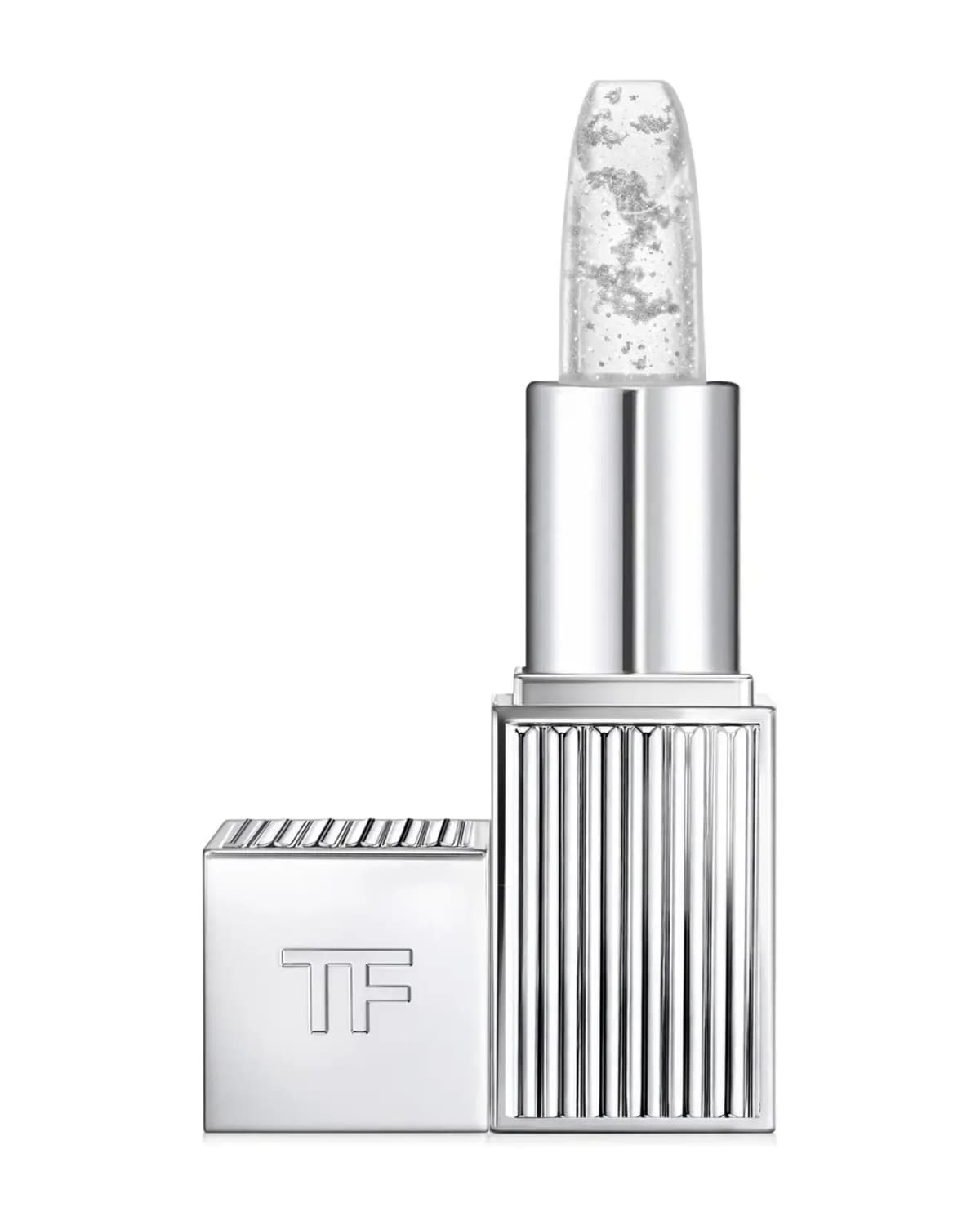 Clear Tom Ford Lip Blush bullet with silver flecks in a silver ribbed case beside a TF-embossed cap