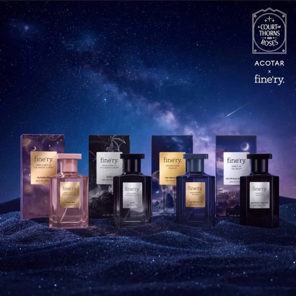 Four fine'ry x ACOTAR perfume bottles in pink, black, blue and dark purple with boxes on glittering sand under a starry sky