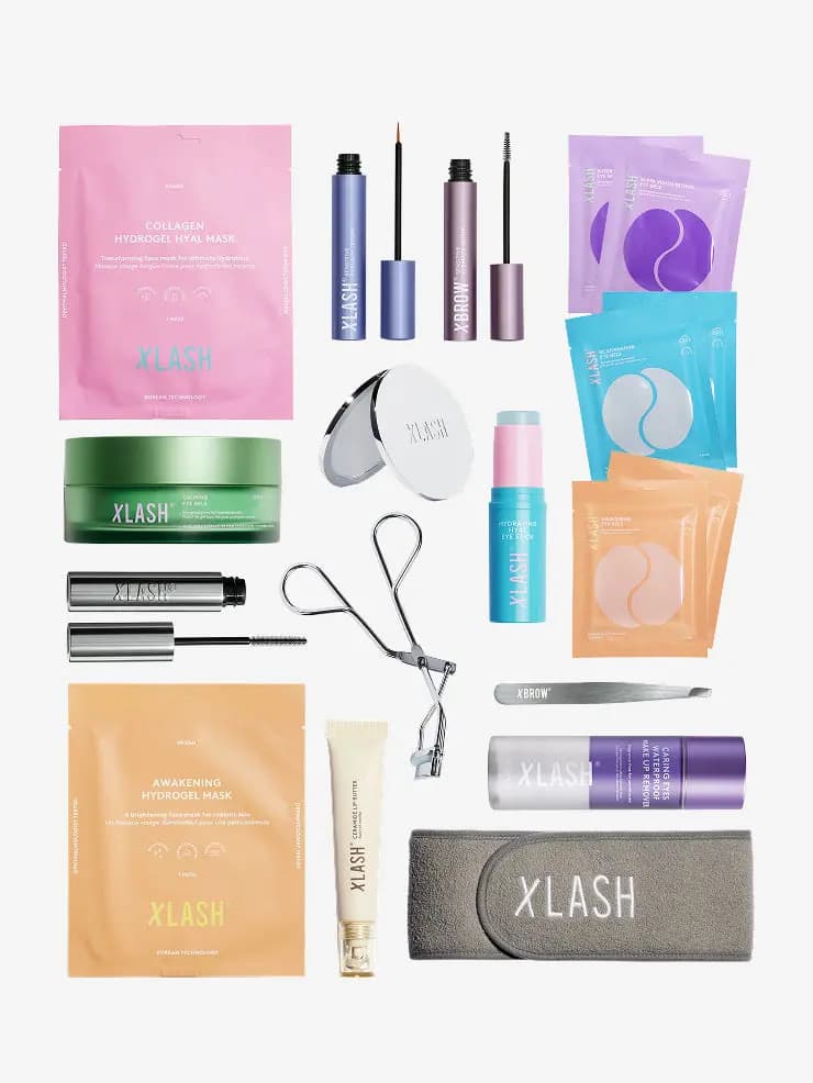 Flat lay of Xlash items: hydrogel masks, lash and brow serums, eye gel patches, curler, tweezers, mascara and grey headband