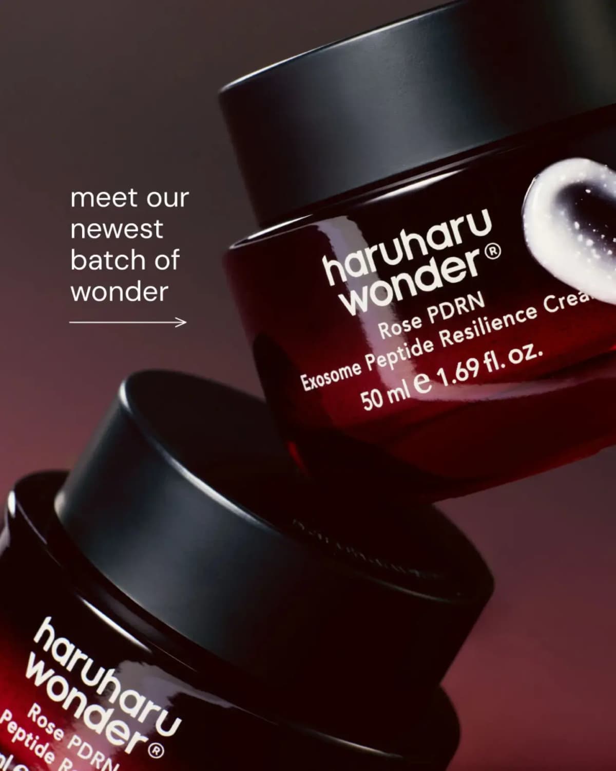 Haruharu wonder Rose PDRN Exosome Peptide Resilience Cream jars, deep red glass with black lids, stacked with a cream swatch