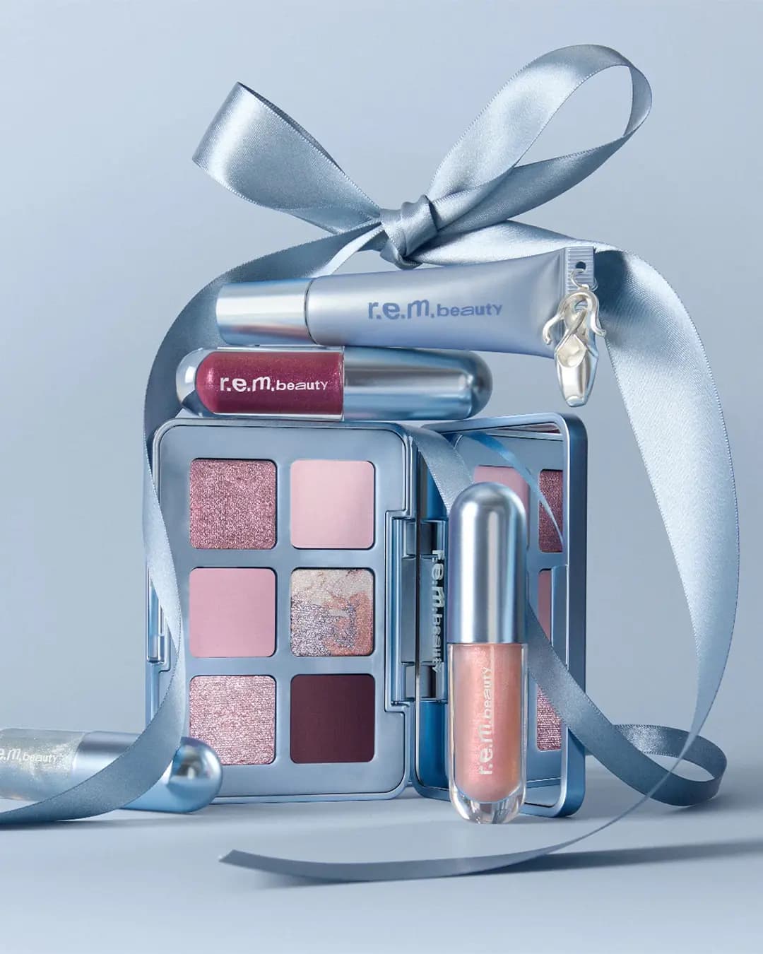 Prima Palette, berry and peach glosses and a lip mask tube with ballet charm wrapped in pale blue satin ribbon