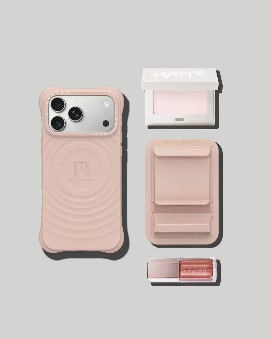 Flat lay of the pink ripple case, pink MagSafe holder, white Fenty Beauty Matte compact and a shimmery lip gloss