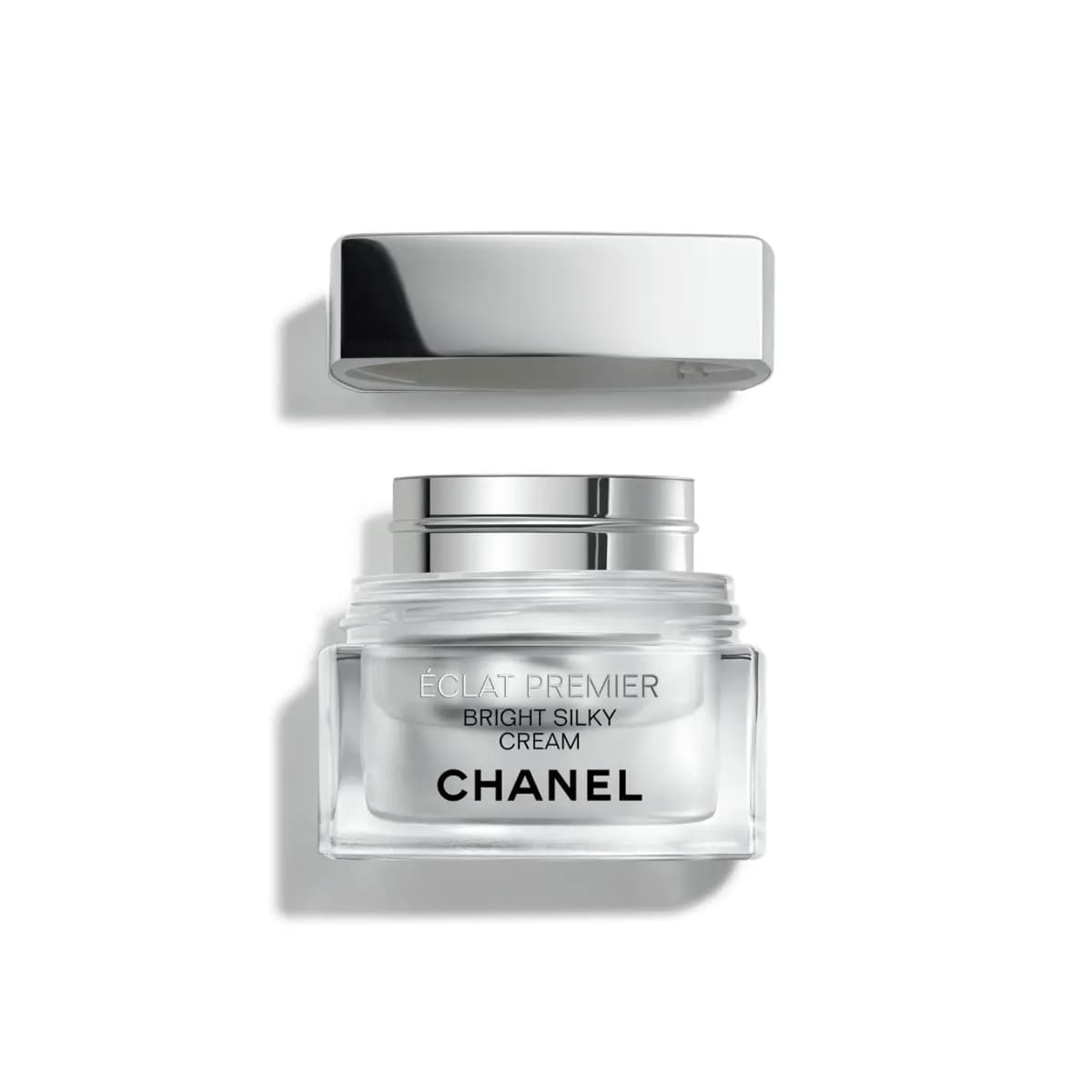 Éclat Premier Bright Silky Cream jar with the silver lid lifted off, revealing the removable silver refill pod inside