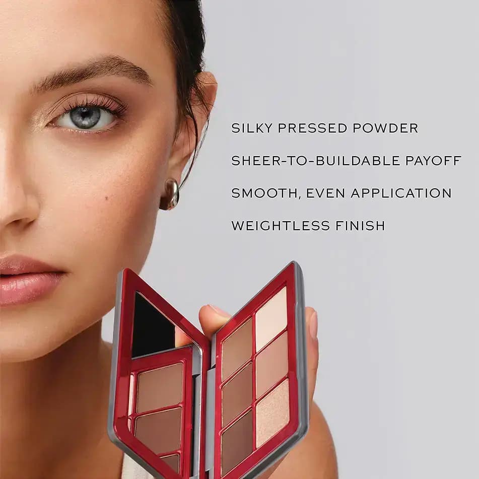 Model holds the open red palette by her face beside text: silky pressed powder, sheer-to-buildable, weightless finish
