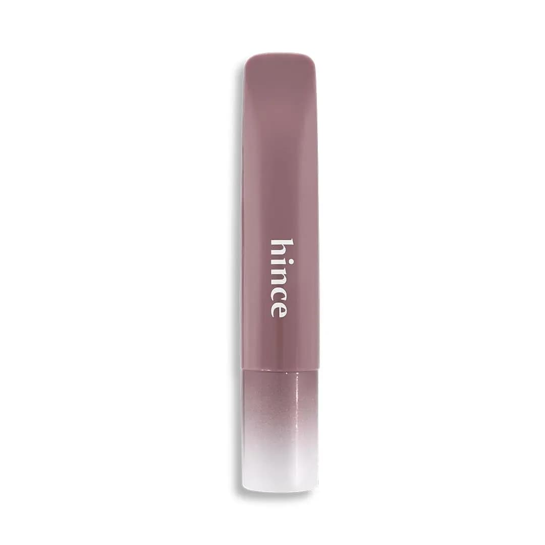 Muted mauve hince lip balm tube with white logo and mauve-to-white gradient cap