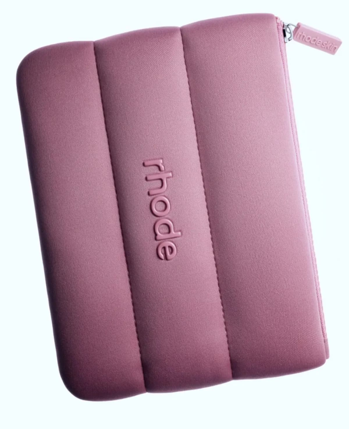 Mauve-pink puffy quilted Rhode zip pouch with embossed logo and rhodeskin zipper pull on light background