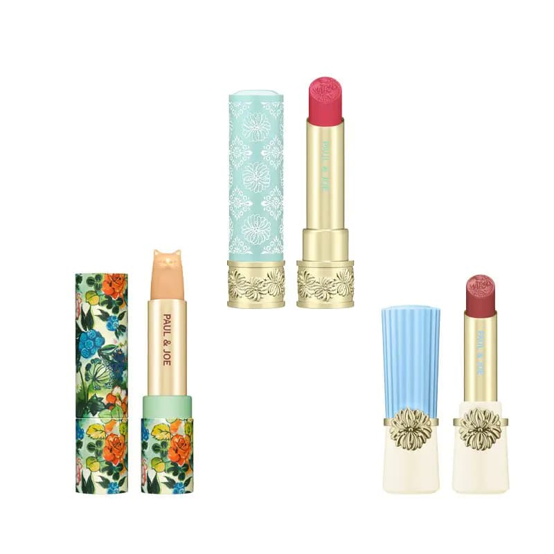 Three Paul & Joe lipsticks: a cat-shaped balm in a floral case, a pink bullet in mint, and a rose shade with blue cap