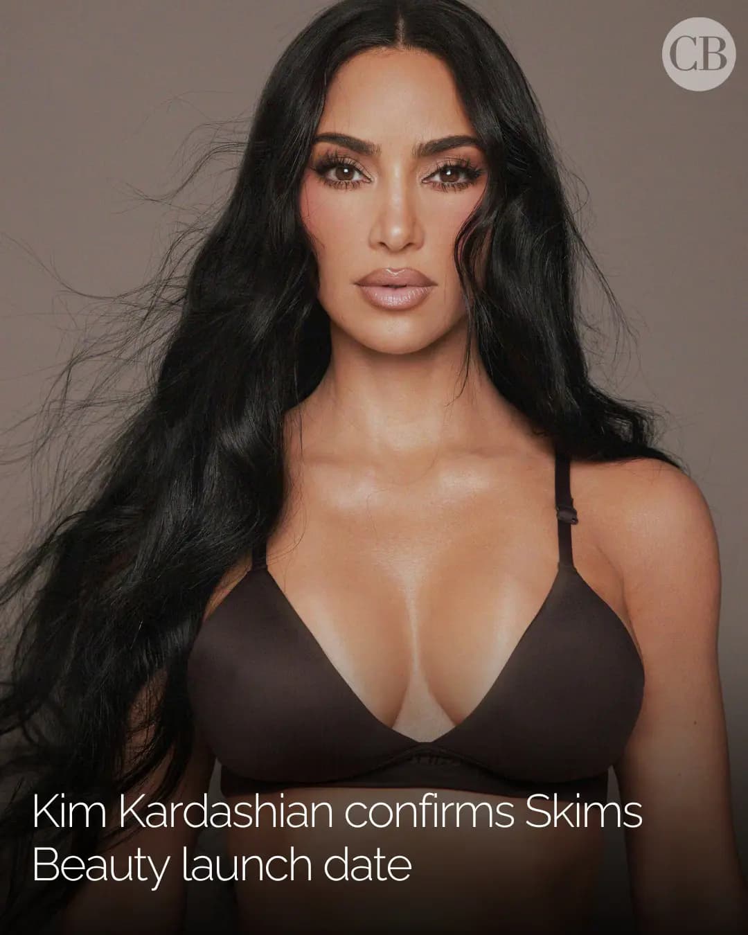 Kim Kardashian with long black hair and nude makeup wearing a brown triangle bra, with text confirming SKIMS Beauty launch