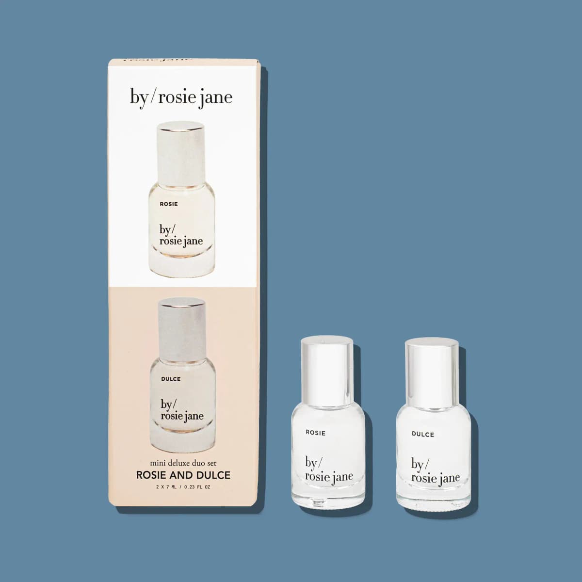 Mini Deluxe Duo Set box shown upright beside clear Rosie and Dulce mini bottles with silver caps on a blue background