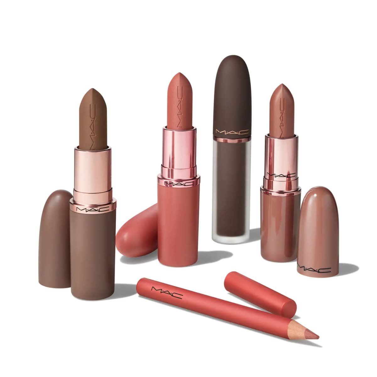 Nude and brown M·A·C lipsticks with rose-gold accents, a dark liquid lip and a coral lip pencil with its cap.