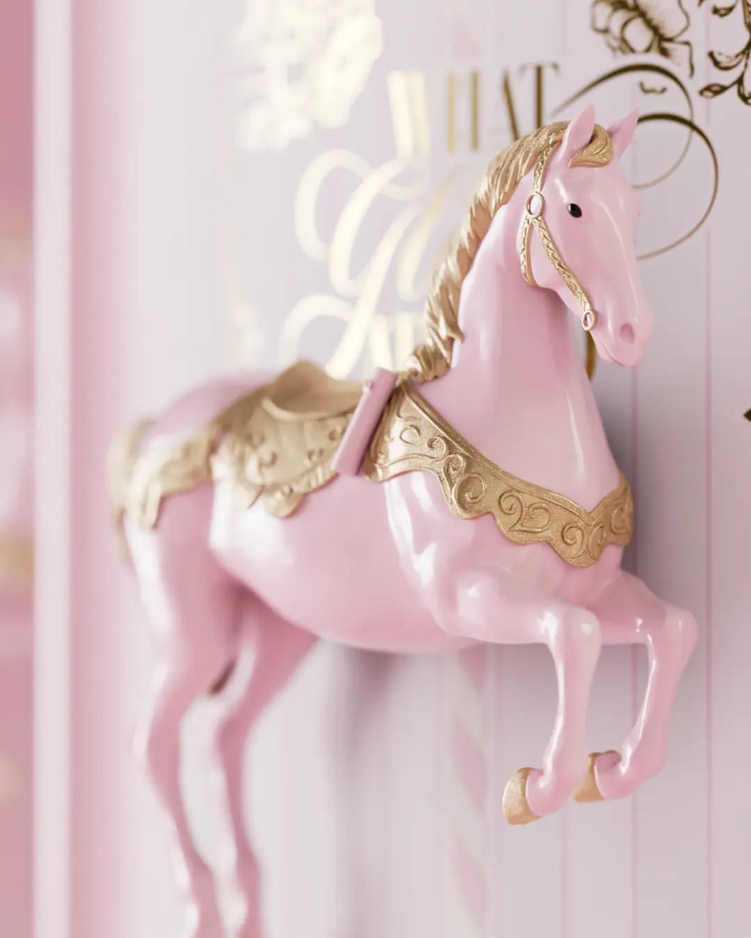 Close-up of a pink and gold carousel horse on the P.Louise What Glows Around 2026 Advent Calendar