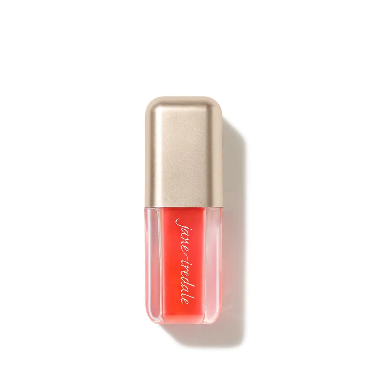 Jane iredale lip oil in a clear tube showing coral-orange oil, topped with a champagne-gold cap, on a white background.
