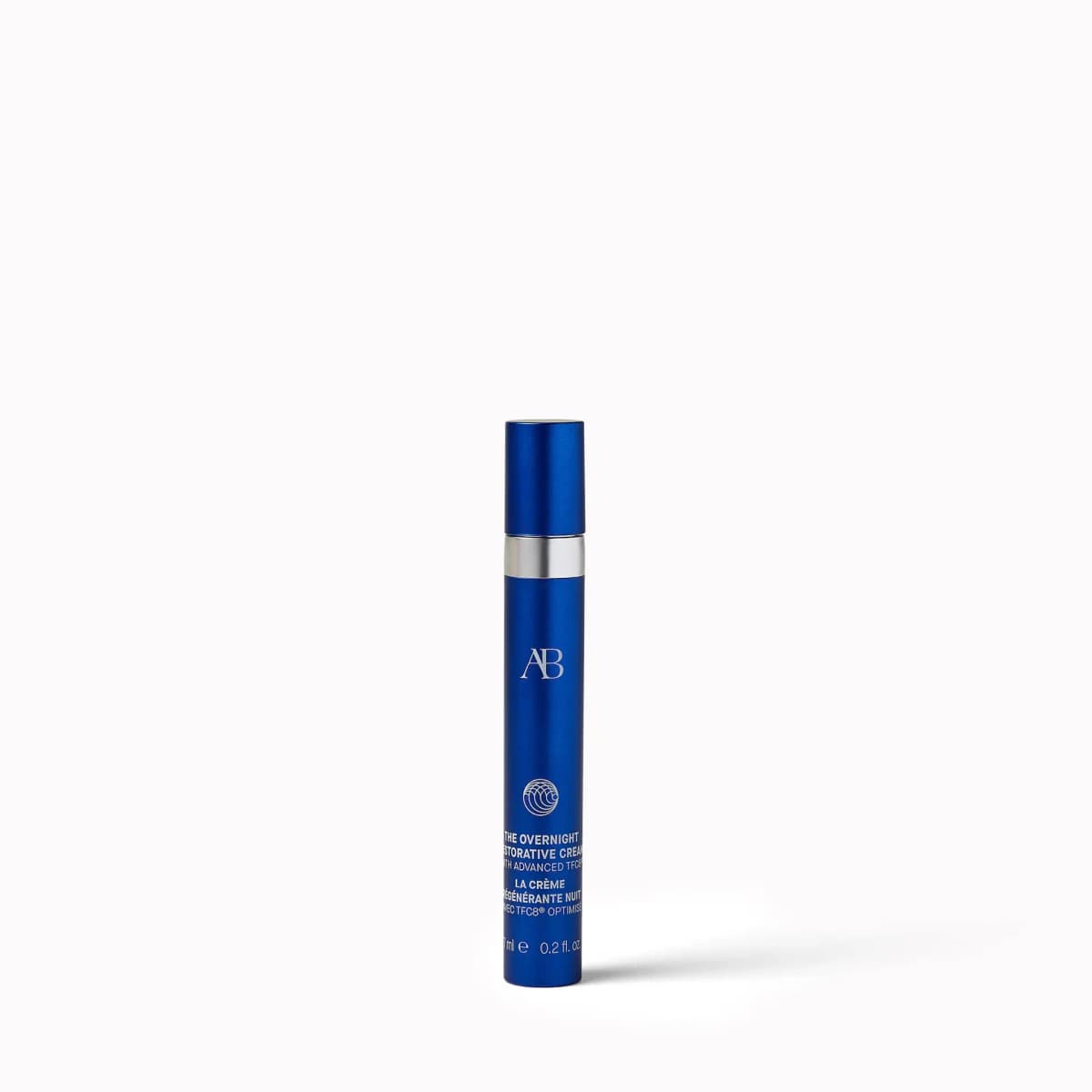 Slim matte blue Augustinus Bader The Overnight Restorative Cream tube with silver band, 7ml, on white