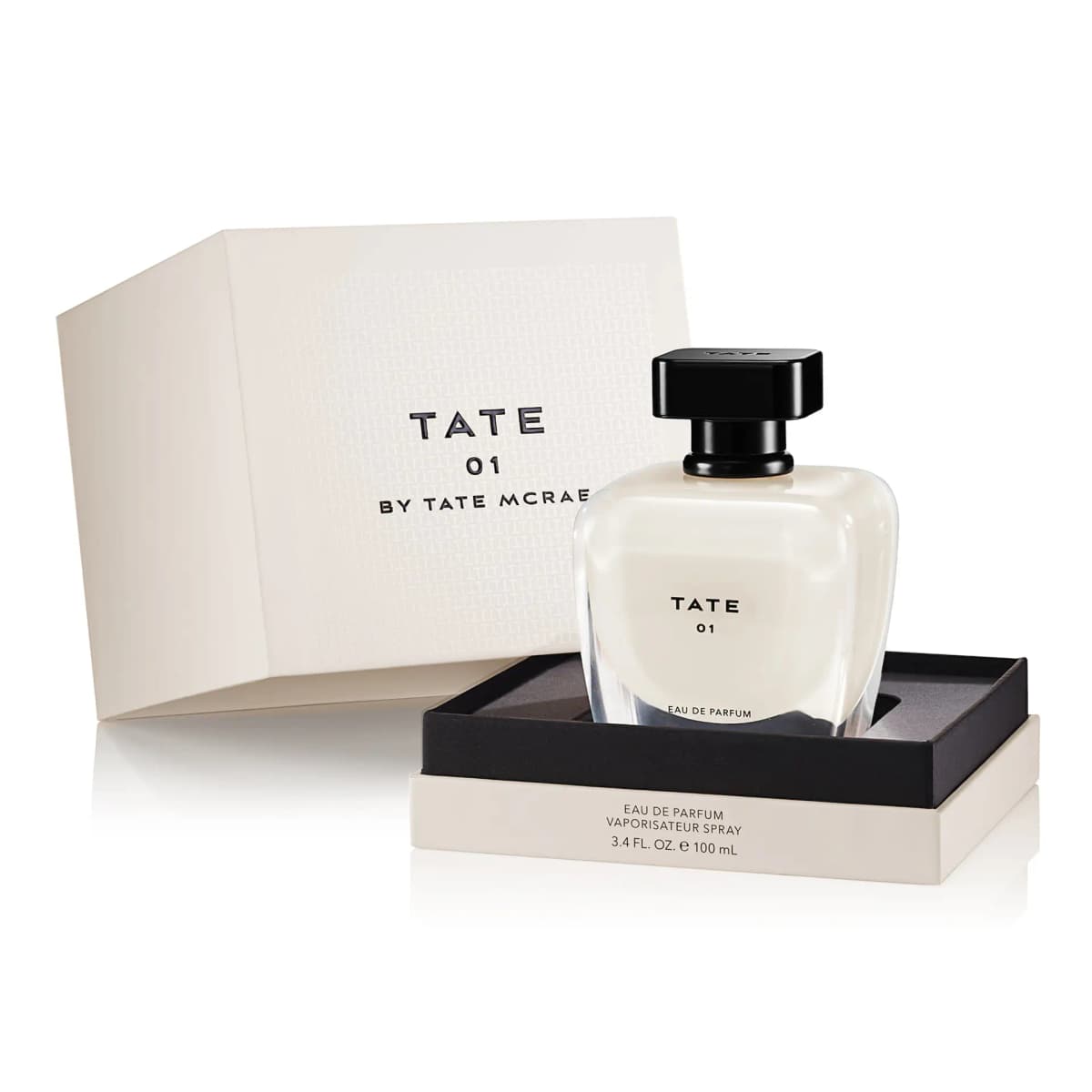 TATE 01 bottle in an open cream box with black insert, lid reading TATE 01 By Tate McRae, labelled 3.4 fl oz 100 mL