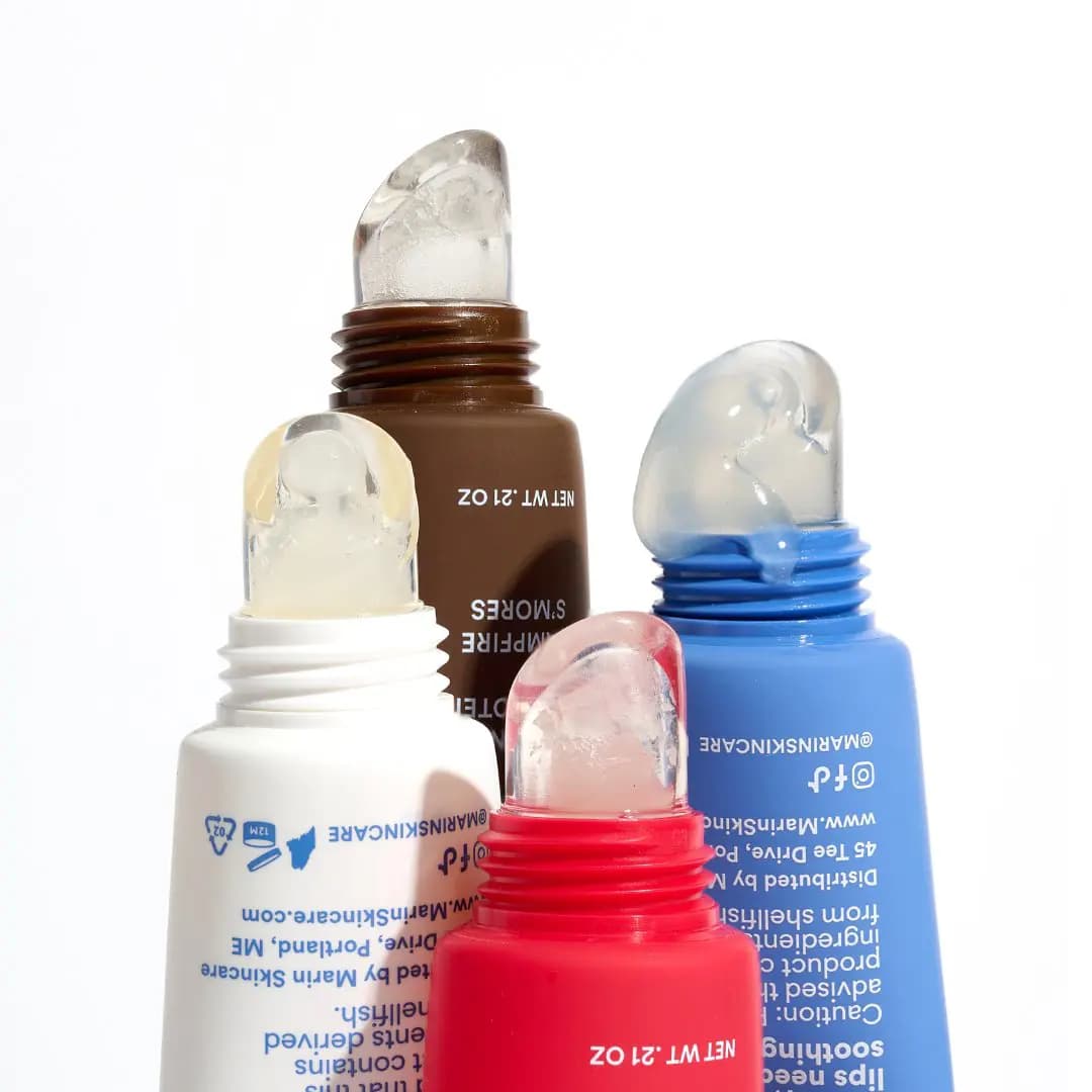 Four uncapped tubes with clear, glossy gel squeezed from the tips against a white background