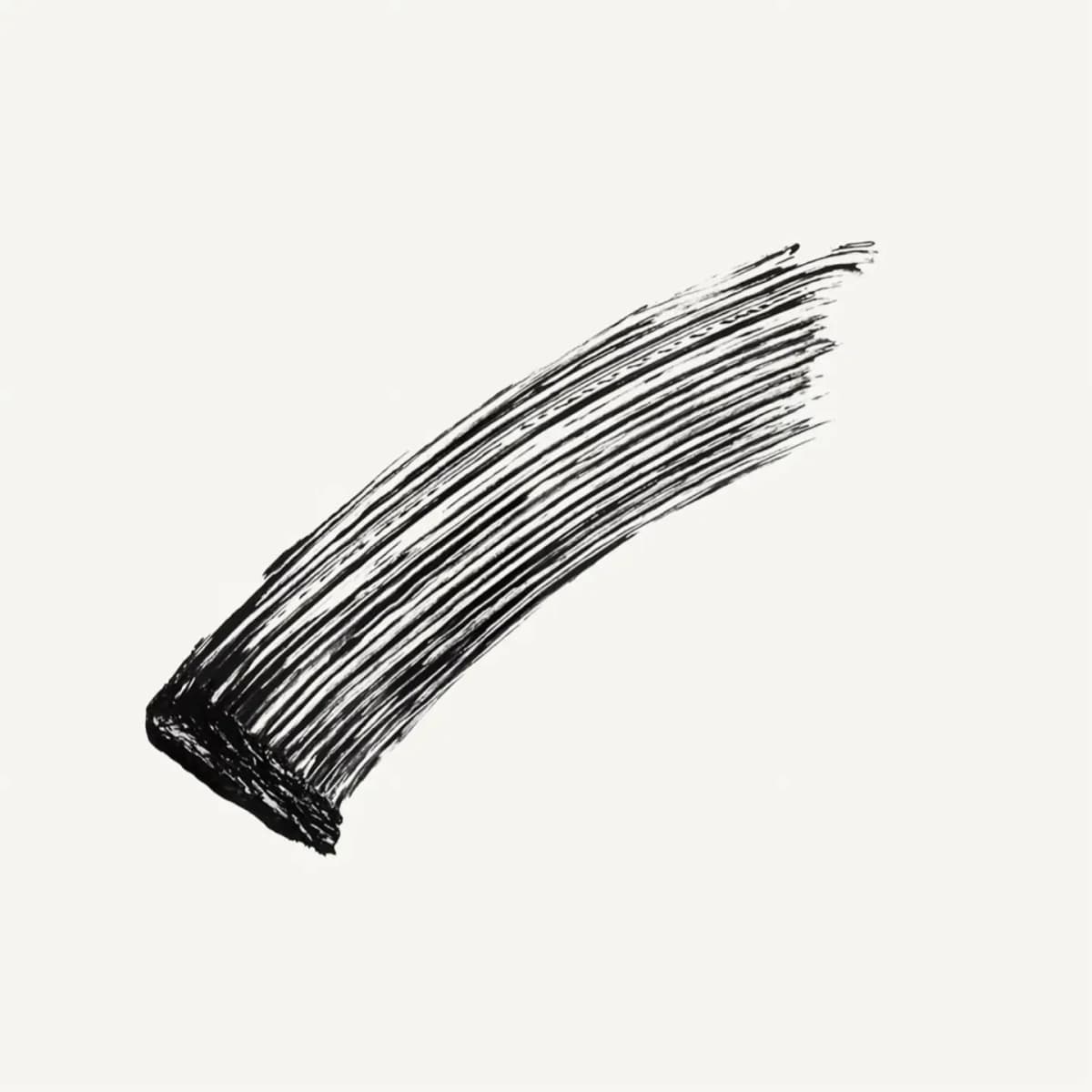 Black mascara swatch brushed in a feathery, curved stroke on a white background