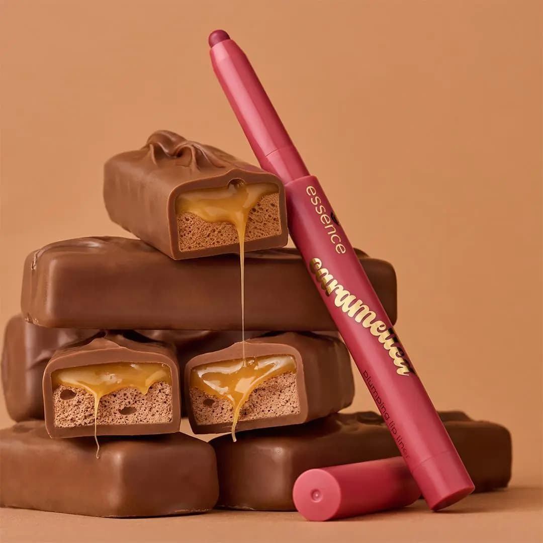 essence caramelted Plumping Lip Liner leaning on stacked chocolate caramel bars