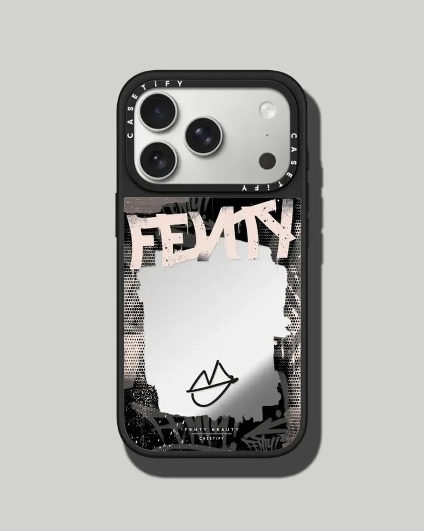 Black iPhone case with pink graffiti "Fenty" lettering around a torn-paper-shaped mirror panel