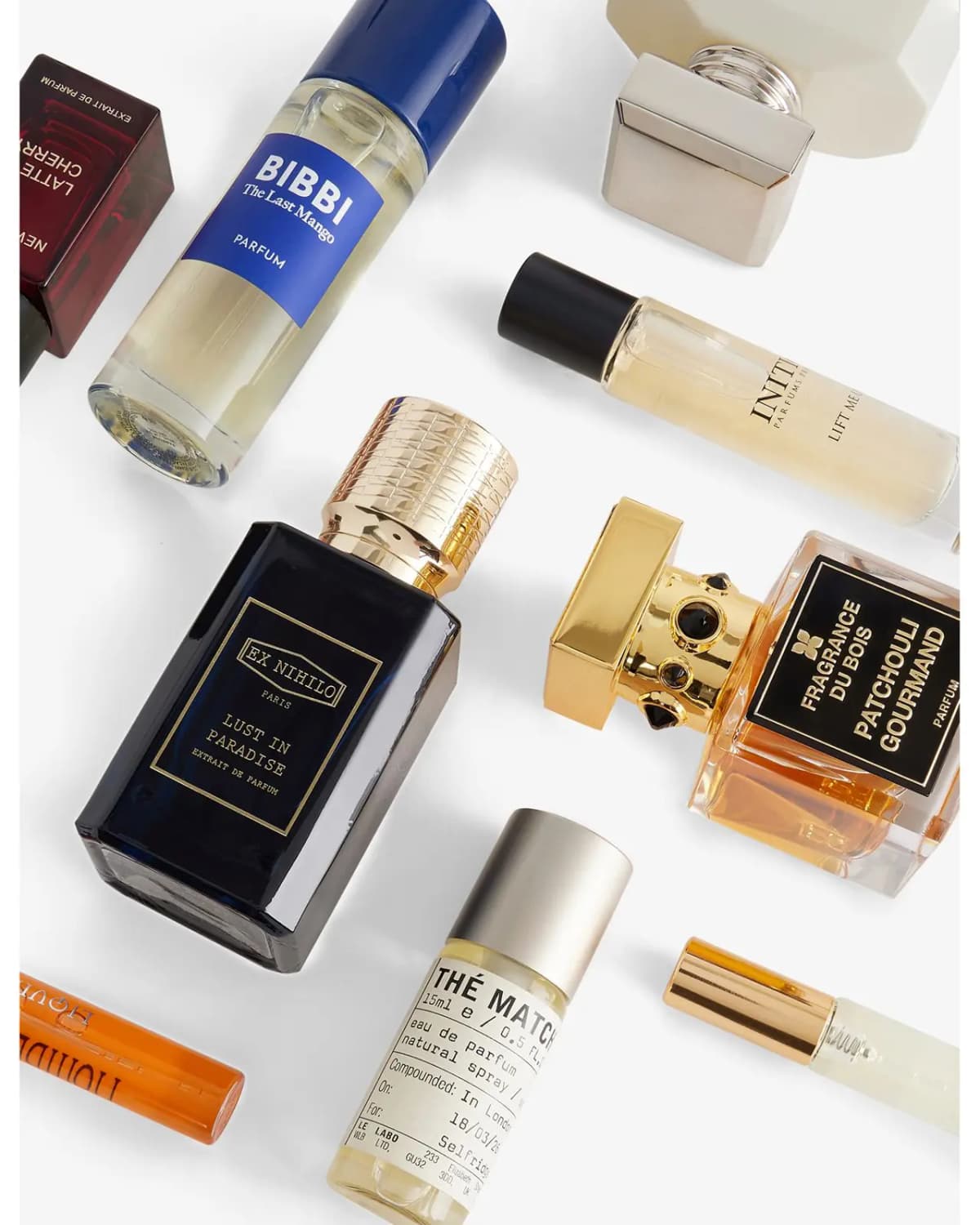 Flat lay of Ex Nihilo Lust In Paradise, Bibbi The Last Mango, Le Labo Thé Matcha and Fragrance Du Bois bottles