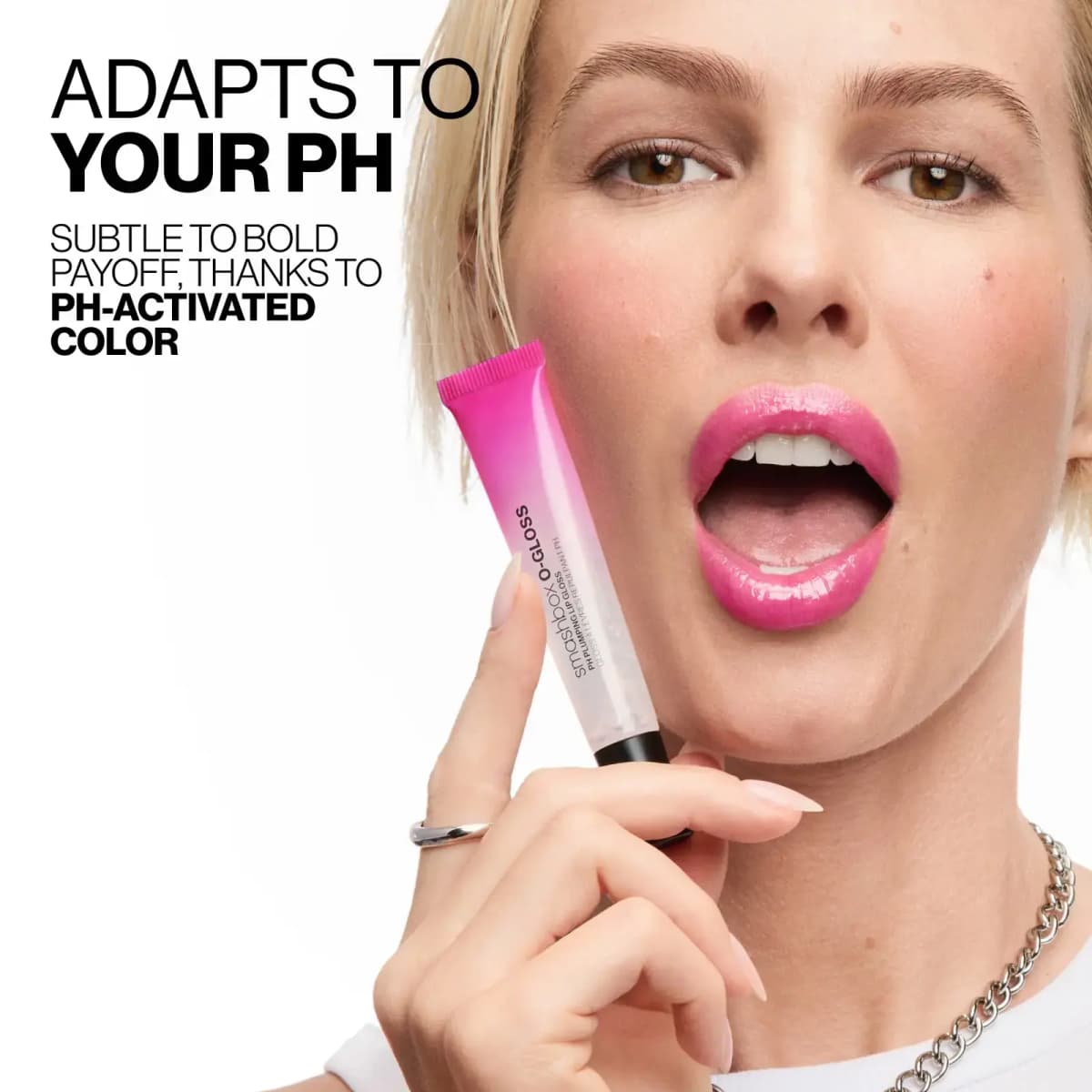 Blonde model with bright glossy pink lips holds the O-Gloss tube beside text "Adapts to your pH