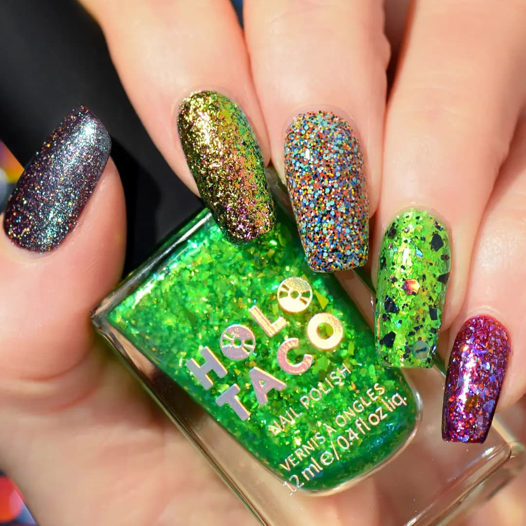 Skittle manicure of five glitter and flake shades held over a green flake Holo Taco nail polish bottle