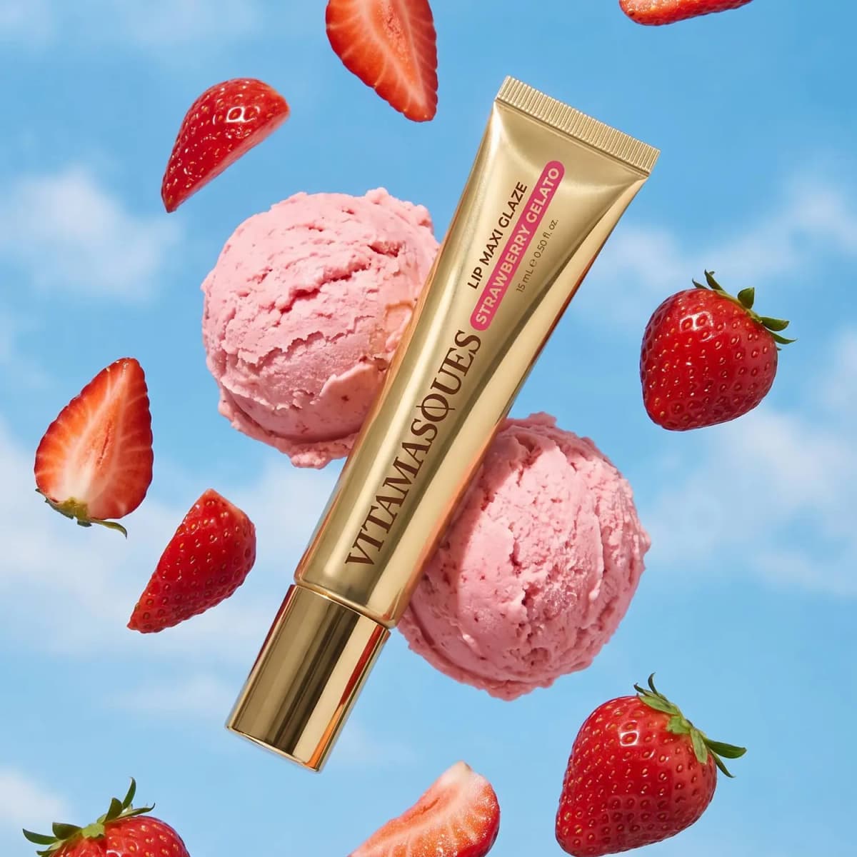Strawberry Gelato Maxi Glaze tube floating with pink gelato scoops and fresh strawberries against a blue sky