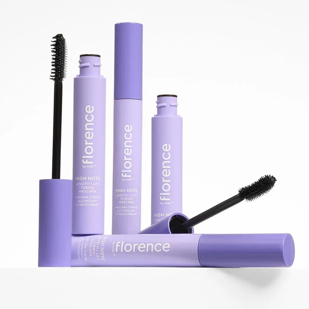 Four lilac High Note mascara tubes grouped together, two open with black wands, on a white background