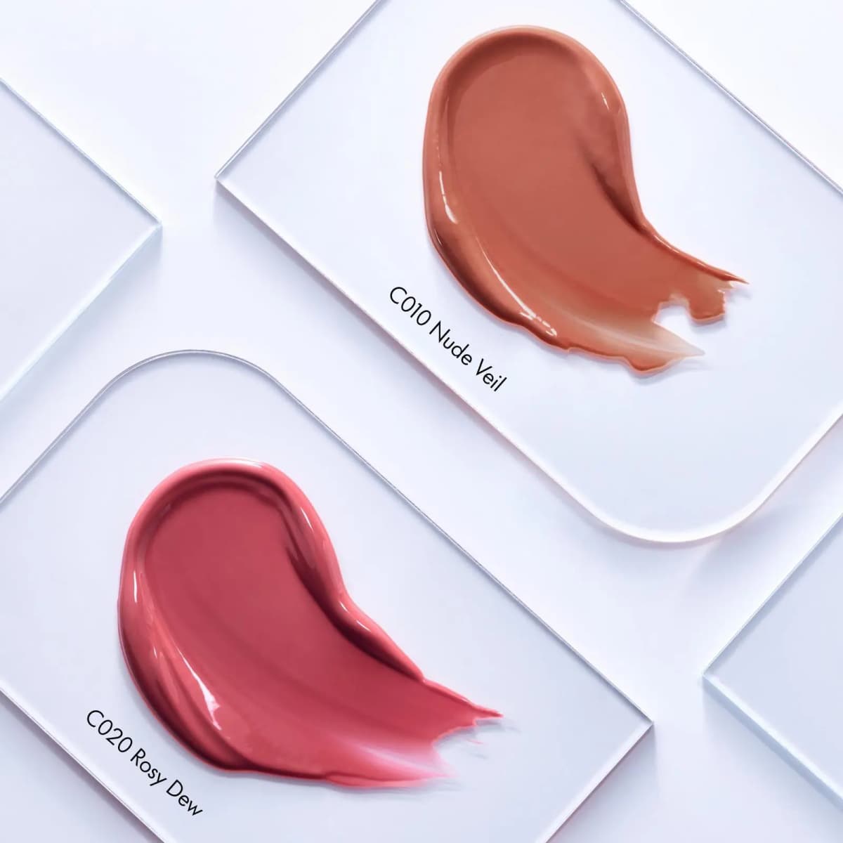 Glossy swatches of C010 Nude Veil and C020 Rosy Dew on clear acrylic plates