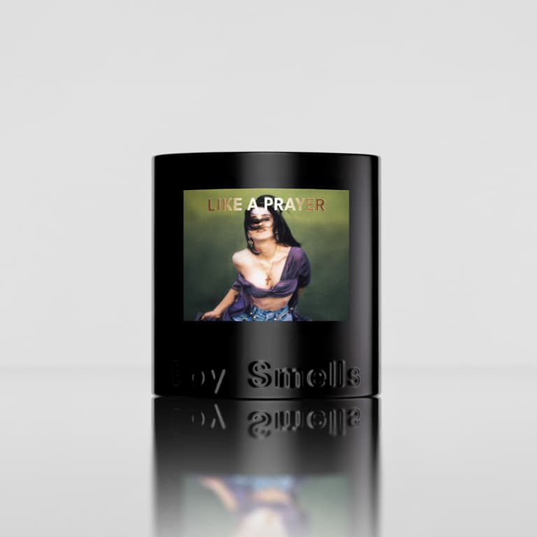 Like a Prayer candle in a glossy black vessel with a green-toned portrait label and embossed Boy Smells logo