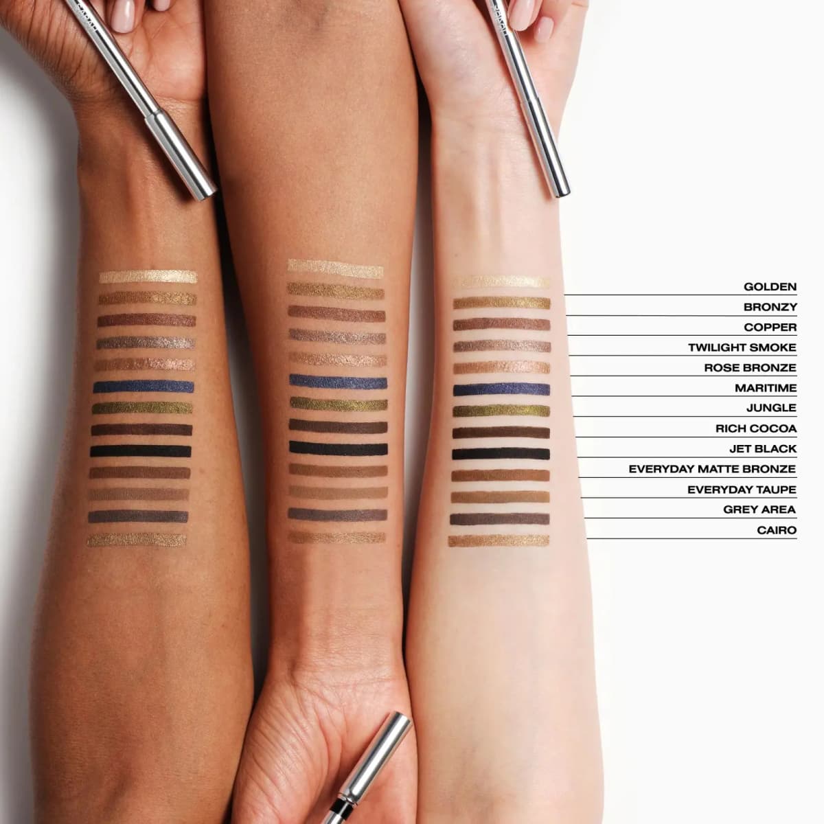 Three arms of different skin tones swatched with 13 Eyes Up liner shades, from Golden to Cairo.