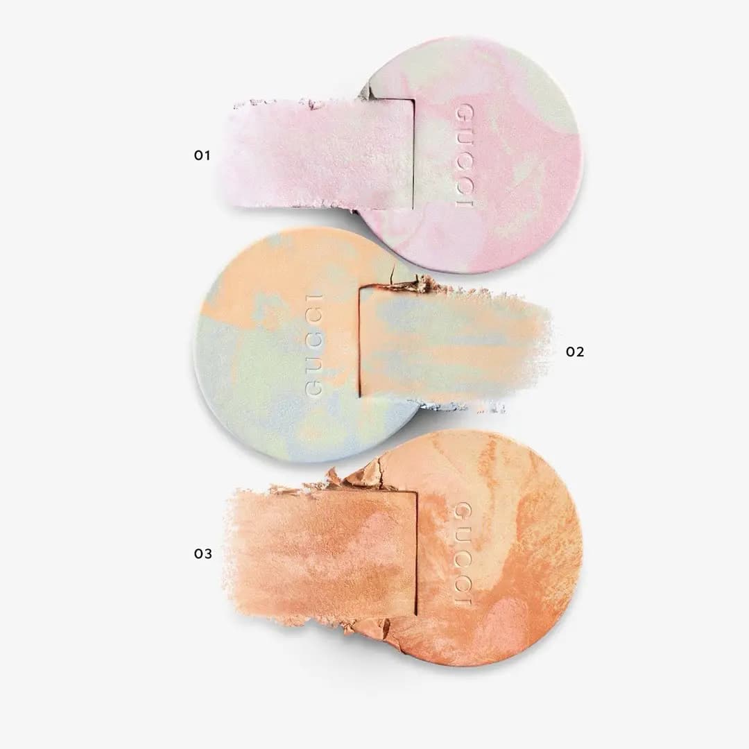 Swatches of shades 01, 02 and 03 smeared from their marbled pressed powder pans on a white background