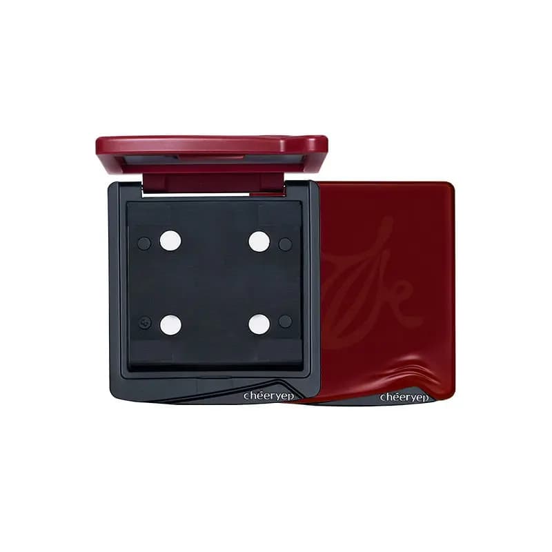 Empty chéeryep refillable compact with four magnets and a red lid, shown open beside its closed red embossed cover