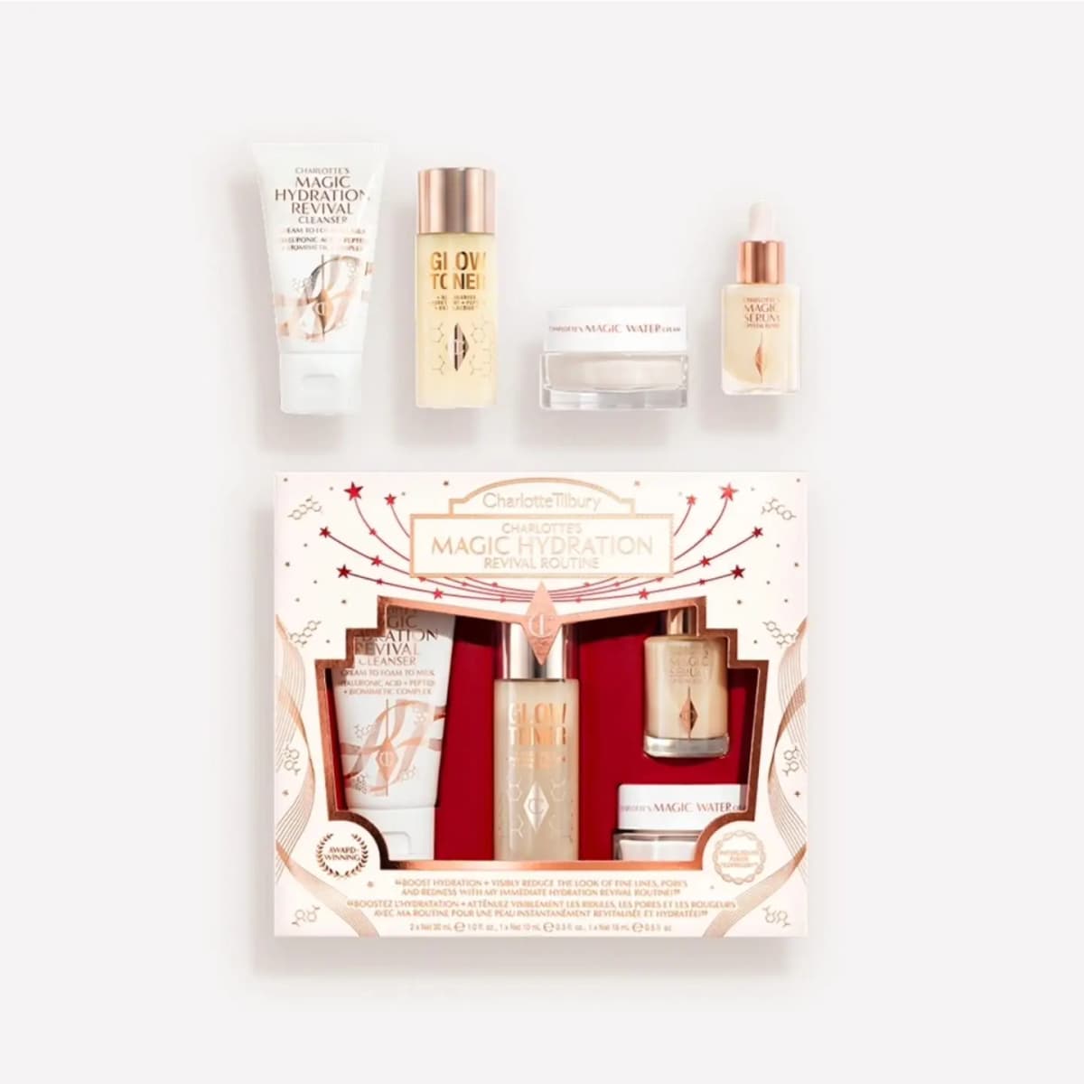Charlotte's Magic Hydration Revival Routine: cleanser, Glow Toner, Magic Water Cream and Magic Serum in a white-red box