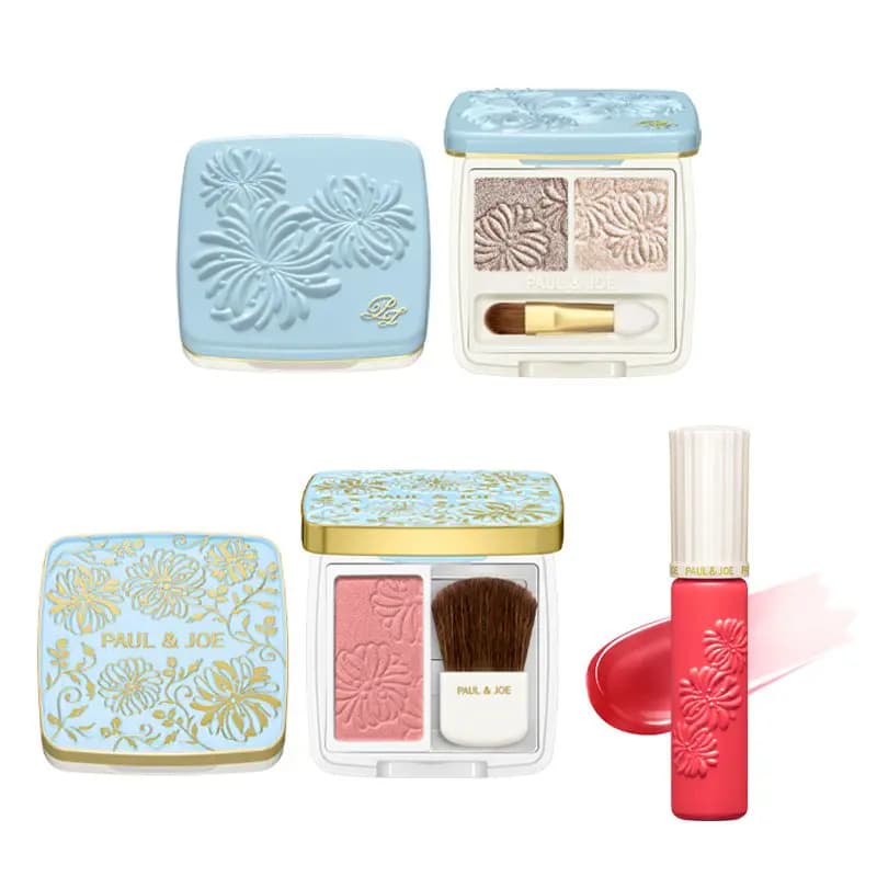 Pale blue embossed eyeshadow duo and pink blush compacts beside a coral lip gloss with a glossy swatch