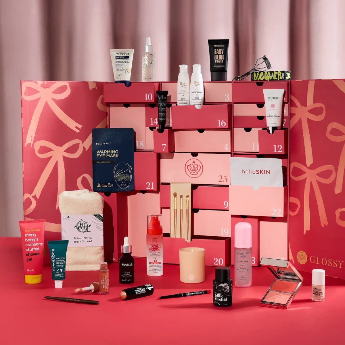 Opened Advent Calendar with drawers pulled out and products such as Aveeno lotion, Rodial drops and a candle displayed