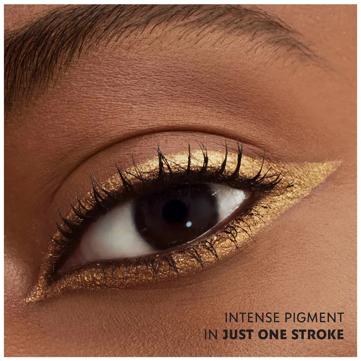 Brown eye on deep skin lined in metallic gold with a wing, captioned "Intense pigment in just one stroke.