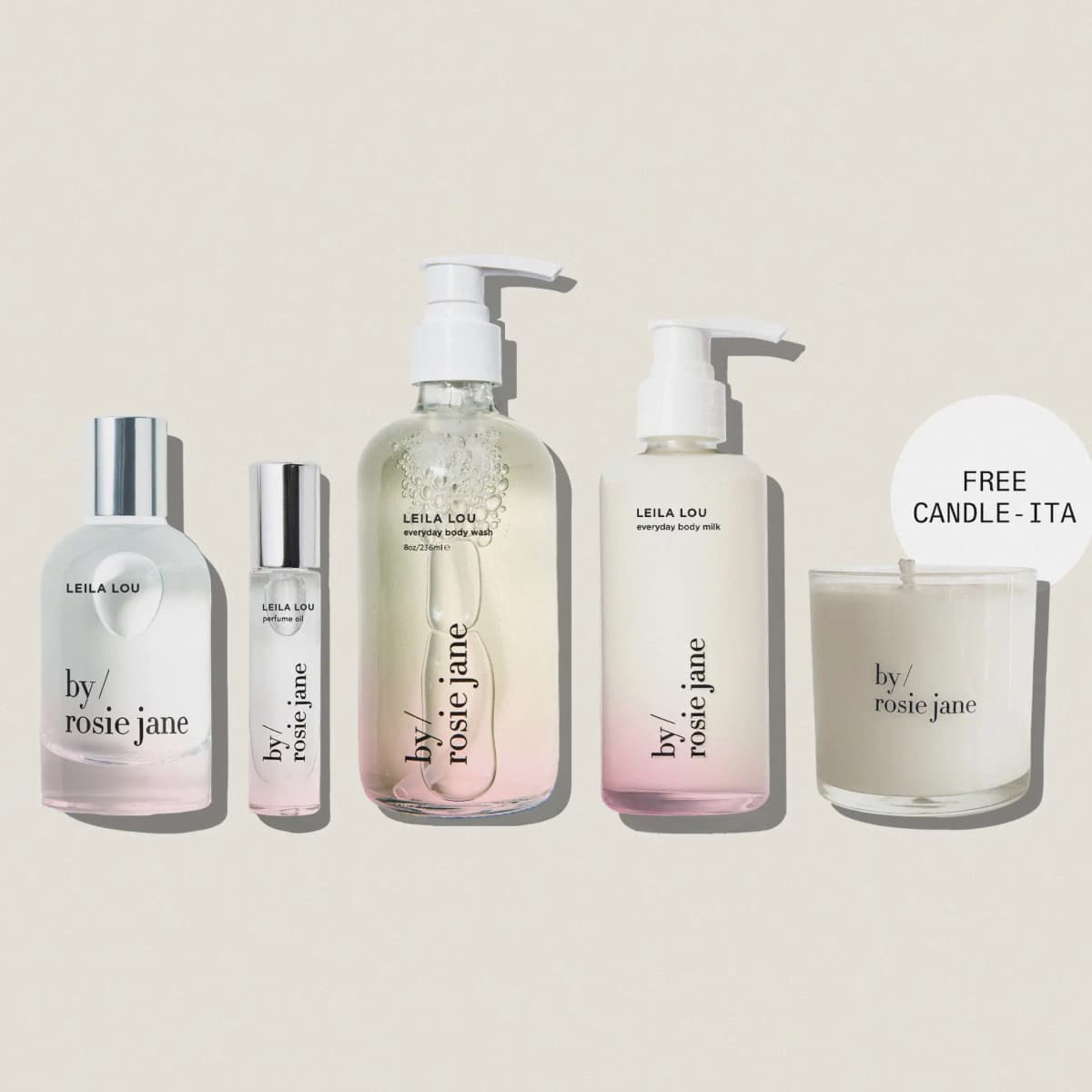 Leila Lou perfume, perfume oil, body wash and body milk in pink-tinted bottles plus a candle marked Free Candle-ita