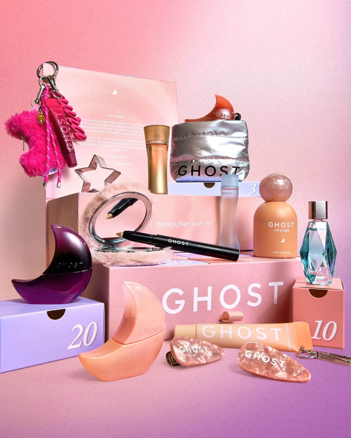 Ghost moon-shaped perfumes, Orb of Night hair perfume, silver puffer pouch and furry compact mirror on the pink calendar